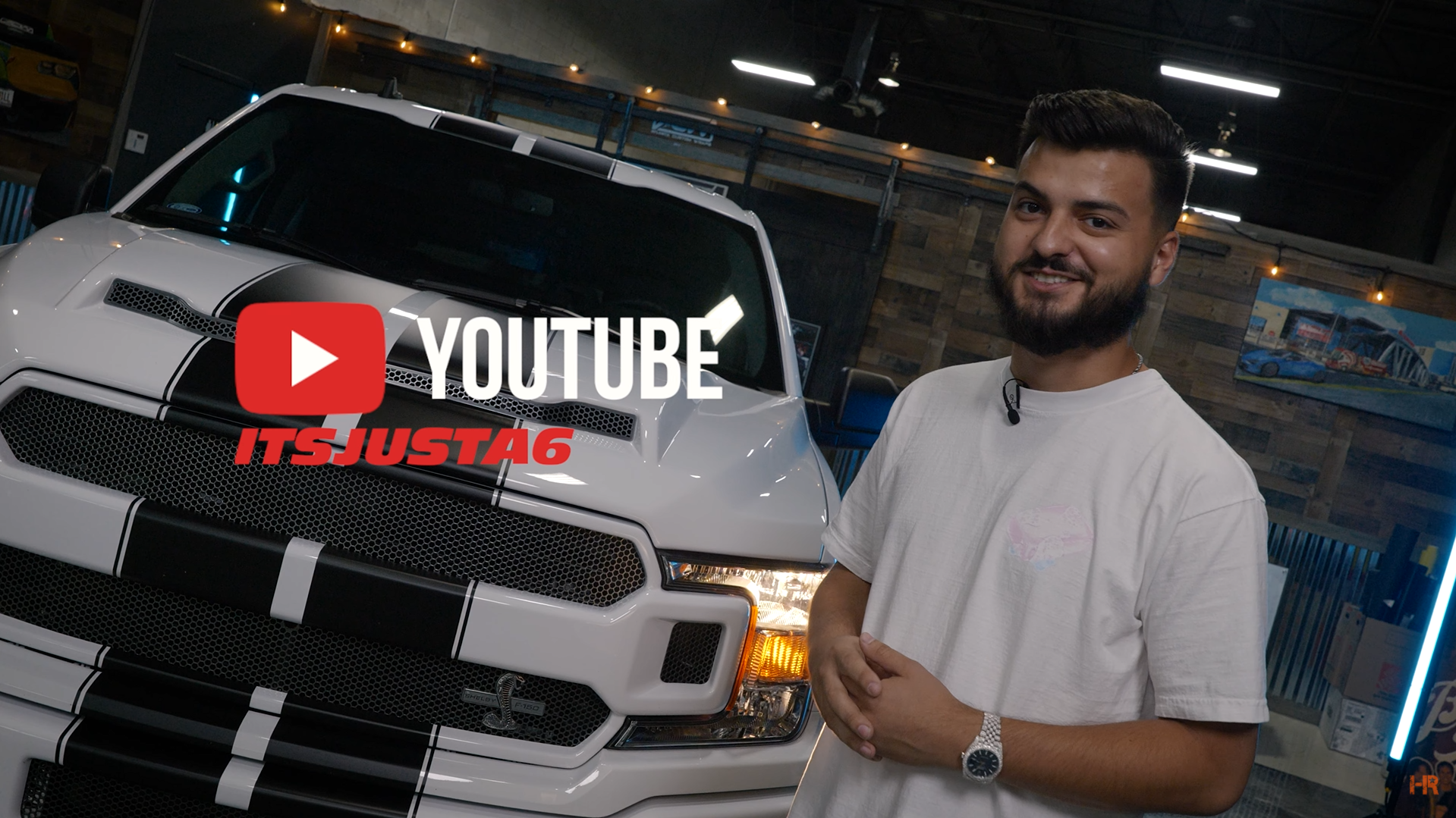 Itsjusta6 standing in front of his Ford F-150 Shelby Super Snake.