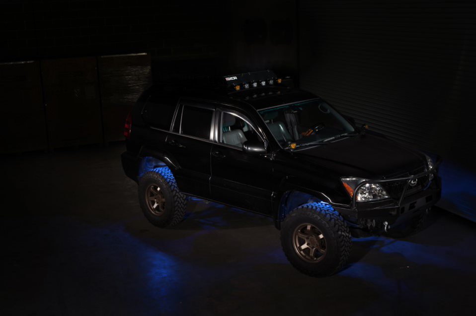 black-suv-in-a-dark-room-with-blue-lights