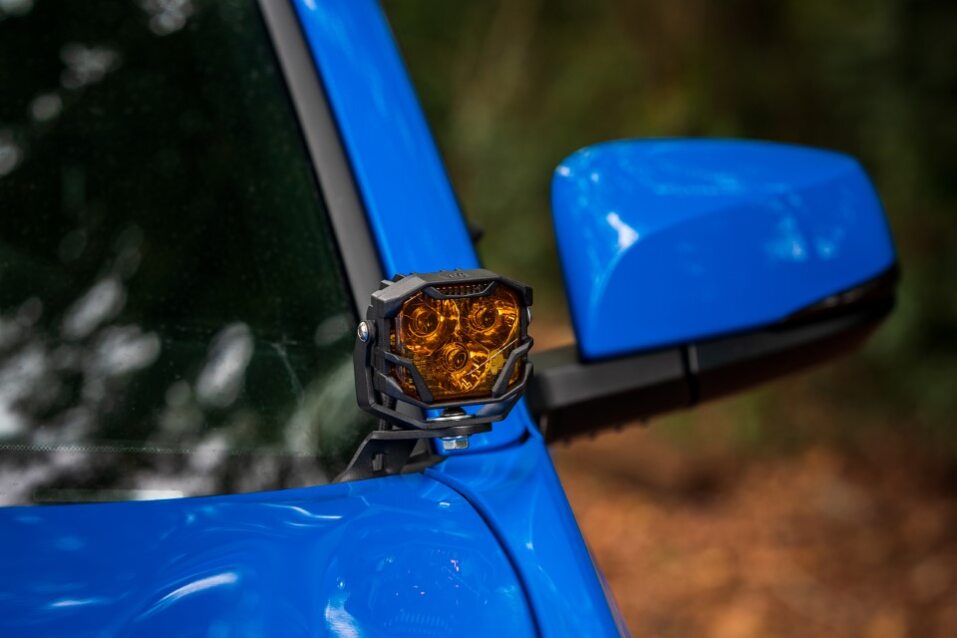a-blue-truck-with-a-light-on-the-side-mirror